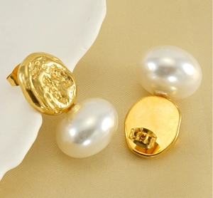 Macro detail of French vintage pearl earrings with gold irregular lava texture