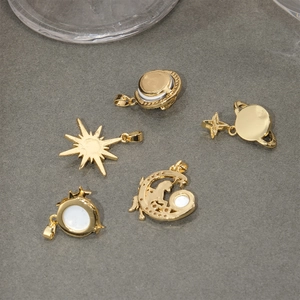 Set of five gold celestial pendants featuring Saturn moon sun and UFO motifs with shell inlay