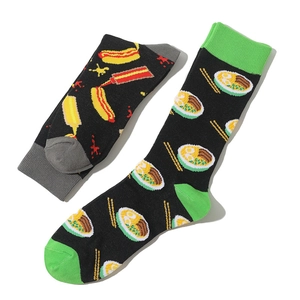 Detail of cotton crew socks featuring cartoon hot dog and ramen prints on black fabric