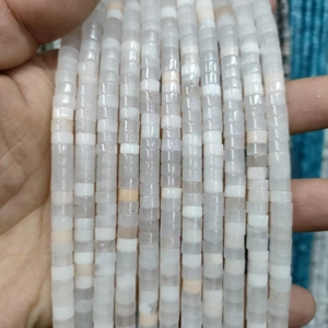 Detailed macro view of semi-transparent cylindrical natural white crystal stone beads