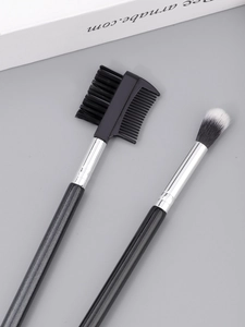 Detail shot of dual-ended eyebrow brush with lash comb and soft blending brush