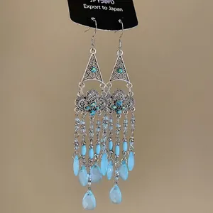 Ethnic bohemian drop earrings featuring blue crystals and cascading tassel chains for women