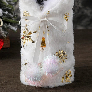 White plush Christmas wine bottle cover with gold snowflakes and velvet ribbon ties