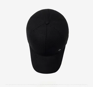 Top view of a black winter baseball cap featuring textured vertical ribbed fabric and metal logo