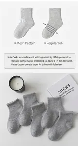 Detail of grey mesh and classic knit kids socks with size guide and aesthetic styling