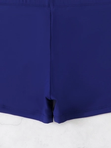 Detailed view of royal blue tankini swim shorts featuring reinforced stitching and elastic fabric
