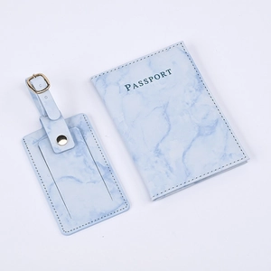 Detail of light blue marble PU leather passport holder and matching luggage tag set