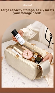 Detail view of large capacity beige makeup bag showing double zippers and spacious storage