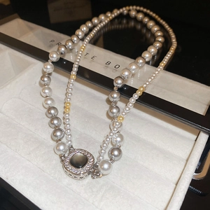 Elegant double-layer pearl necklace with gray and white pearls and jewel-set clasp