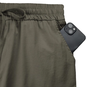 Detail of elastic drawstring waistband and deep side pockets on olive cargo pants