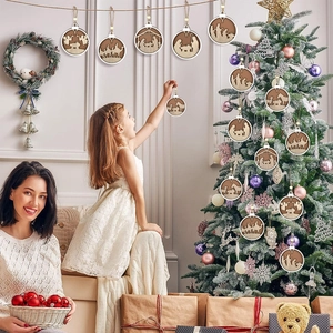 Close-up of wooden Nativity scene ornaments hanging on a Christmas tree during decoration
