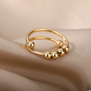 18k gold spiral bead anxiety ring with five movable beads on minimalist double bands