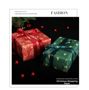 Close-up of Christmas gift box with gold foil patterns and Love Is Eternal satin ribbon