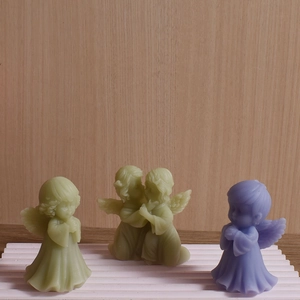 Detailed angel-shaped scented candles and gypsum ornaments in pastel green and purple