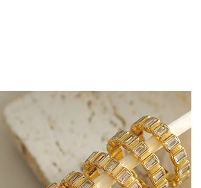 Detailed macro shot of gold plated eternity ring with rectangular zircon inlays