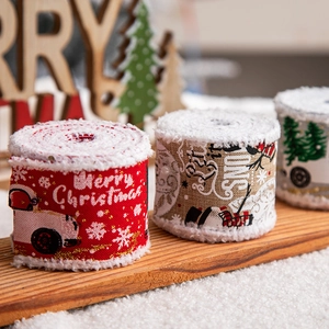 Christmas burlap ribbons with Merry Christmas prints on wooden surface decor