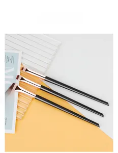 Detailed close-up of three professional angled eyeliner brushes with rose gold ferrules