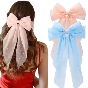 Oversized polka dot tulle bow hair clip with long streamers in pink and blue colors