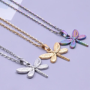 Three minimalist stainless steel dragonfly necklaces in silver, gold and rainbow finishes