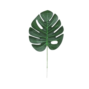 Artificial green Monstera leaf with realistic texture for party and wedding decoration