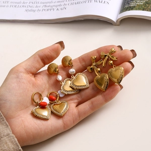 Three pairs of gold titanium steel heart earrings with pearls and bows for women