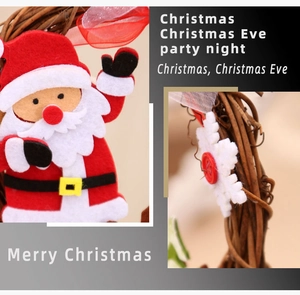 Detail of wooden wicker wreath with red felt Santa Claus and white snowflake decorations