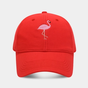 Detailed close-up of pink flamingo embroidery on a red cotton canvas baseball cap