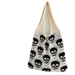 Knitted tote bag with black skull pattern on beige fabric for Halloween street style