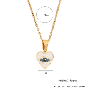 Detail view of gold heart pendant with blue evil eye inlay and size specifications
