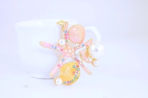 Detail of starfish and seashell keychain with colorful rhinestones and pearls