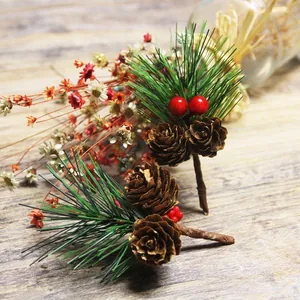 Artificial Christmas pine needles with pine cones and red berries for festive decor