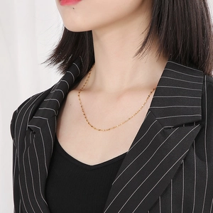 Close-up of golden stainless steel lip chain necklace on neck for elegant style