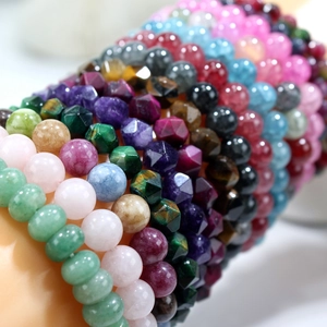 Macro shot of colorful beaded natural stone bracelets with round and faceted gemstones