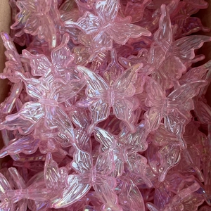 Close-up of translucent pink acrylic butterfly charms for creative DIY phone chains