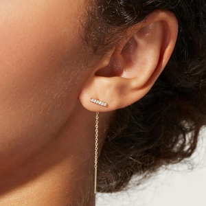 Macro shot of gold plated silver long tassel earrings with sparkling cubic zirconia