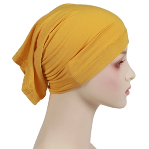Side view of ginger yellow elastic modal hijab cap on mannequin with knit texture detail