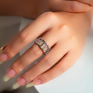 Detailed view of a silver hollow geometric ring featuring a unique trapezoid design