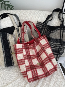 Three oversized faux shearling tote bags in checkered and striped patterns on soft plush rugs