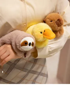 Detail showing soft plush capybara, sloth, and duck slap bracelets on a person's wrist