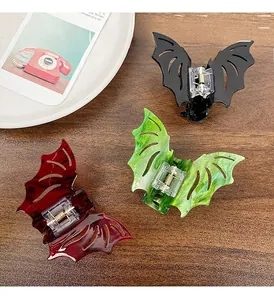 Detailed view of Halloween bat hair claws in black, red marble, and green marble