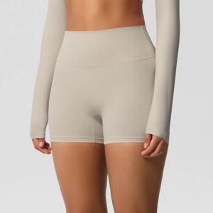 Close-up of high-waisted beige seamless yoga shorts with tummy control and elastic fabric