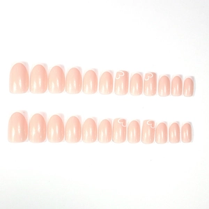 Pink French tip press-on nails with white heart designs and glossy square finish