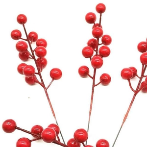 Close-up of vibrant red artificial Christmas berries on stems for holiday home decor