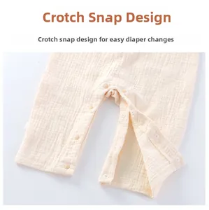 Detailed view of snap closure on cotton gauze baby bodysuit for easy diaper changes