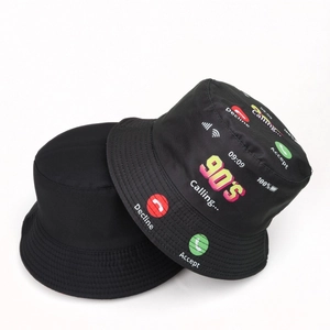 Detail of black reversible bucket hat with 90s vintage phone call graphics on nylon fabric