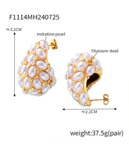 Macro detail of teardrop gold-plated titanium earrings with elegant white imitation pearls