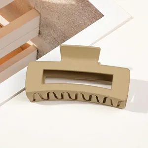 Detail of matte khaki large rectangular hair claw clip with frosted texture finish