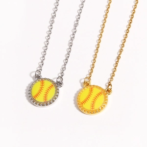 Detailed look at gold and silver baseball pendants with realistic red stitching