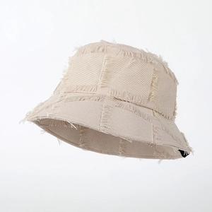 Beige frayed patchwork cotton bucket hat for women with minimalist distressed sun protection
