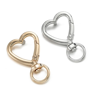 Close-up of gold and silver heart-shaped lobster clasps for DIY jewelry making